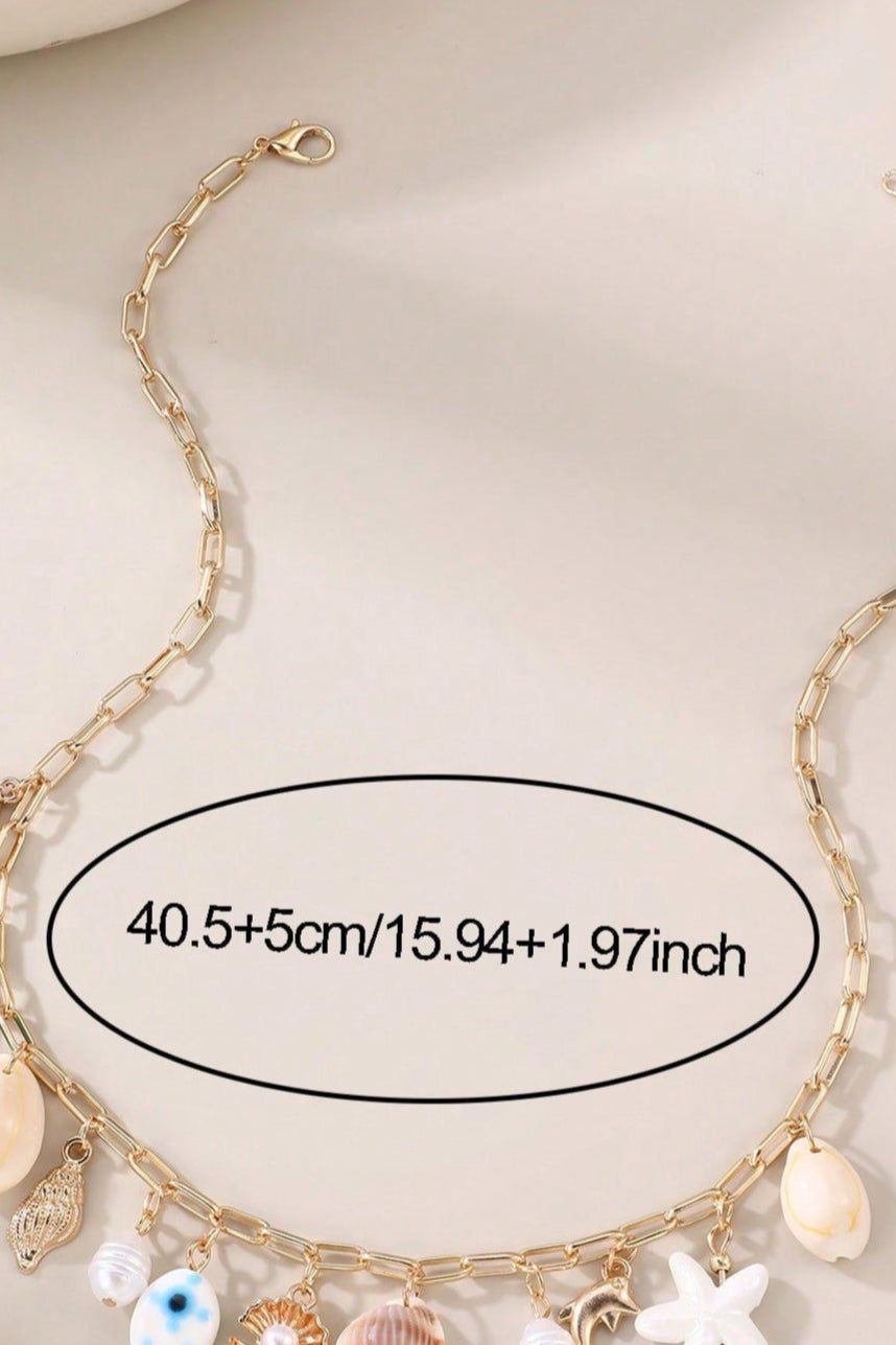 Collana con conchiglia, stella marina e perle